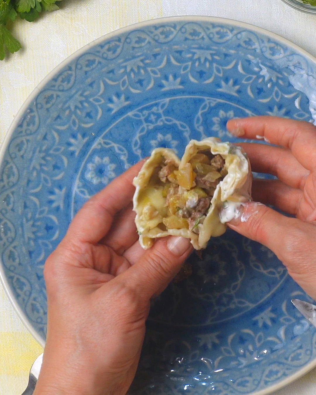 Lamb and pumpkin filling inside a cut manti dumpling